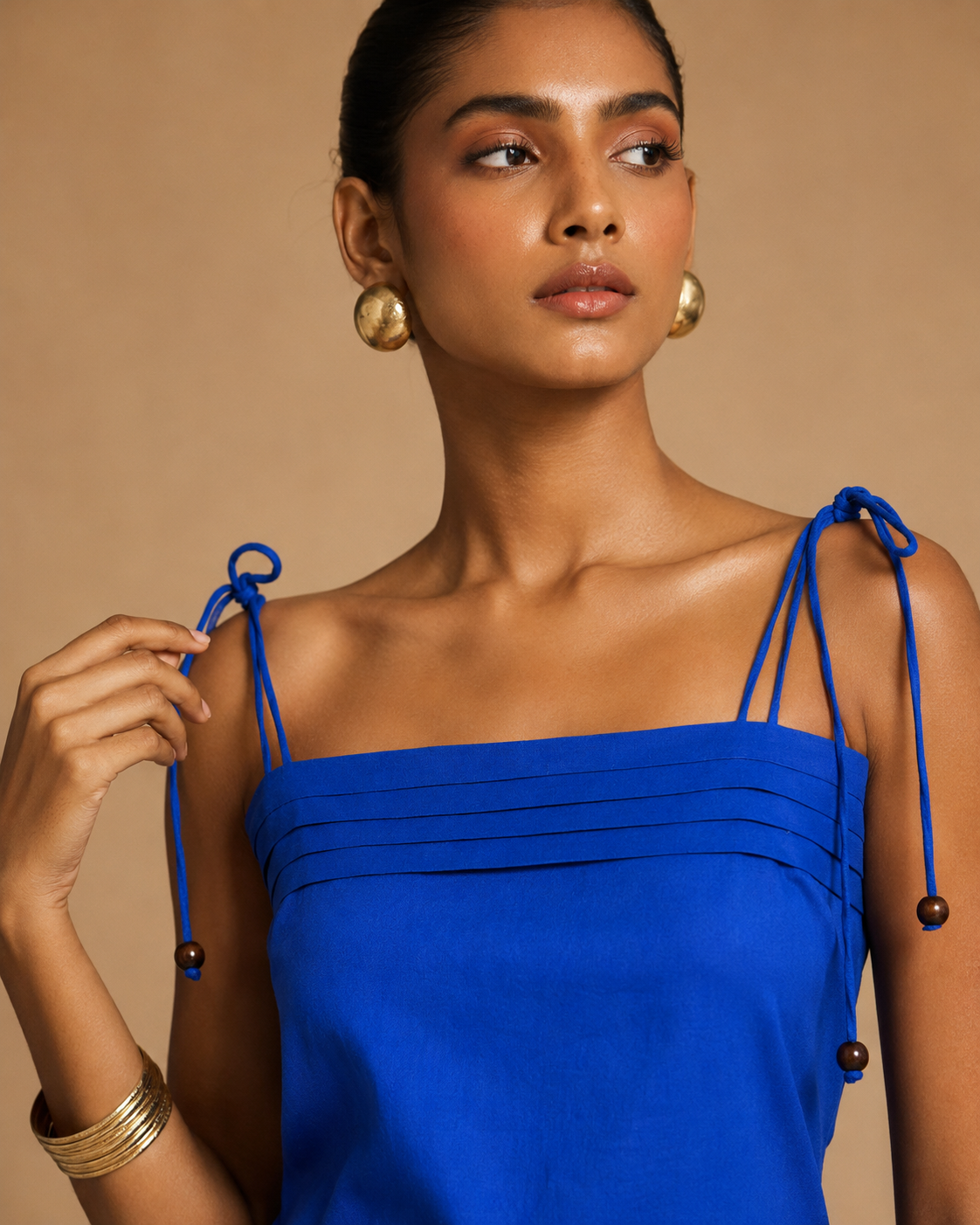 Close-up of cobalt blue cotton kurti pintuck neckline and tie-up straps with wooden beads - Myra by Kavyaantra