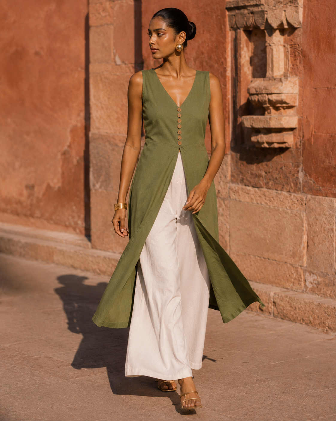 Olive green cotton front-slit kurti angled view with high front slit over cream palazzo - Vanya by Kavyaantra