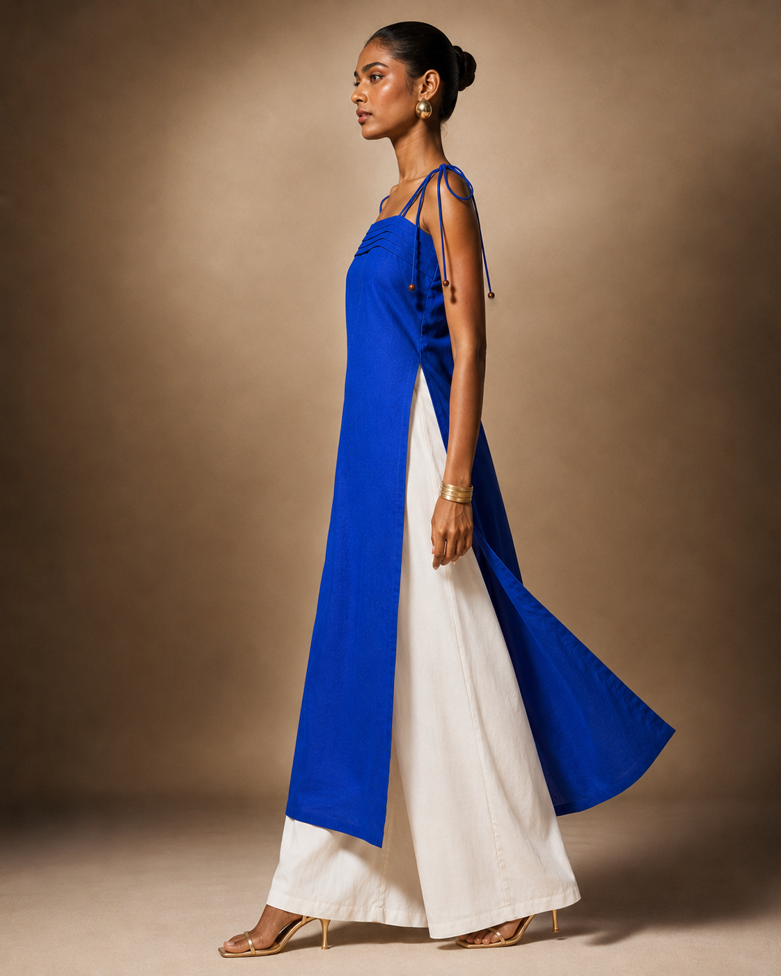 Side view of cobalt blue cotton pintuck kurti with high side slit over white palazzo - Myra by Kavyaantra
