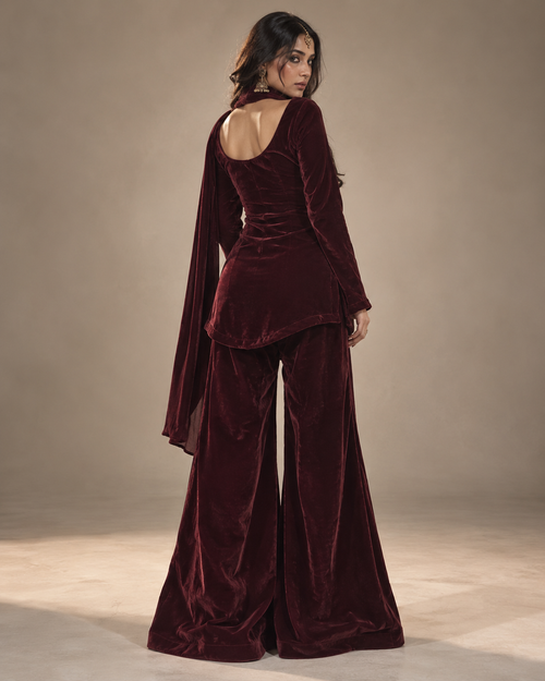 Gul deep maroon velvet sharara set back view with apple-cut kurti hem – Kavyaantra
